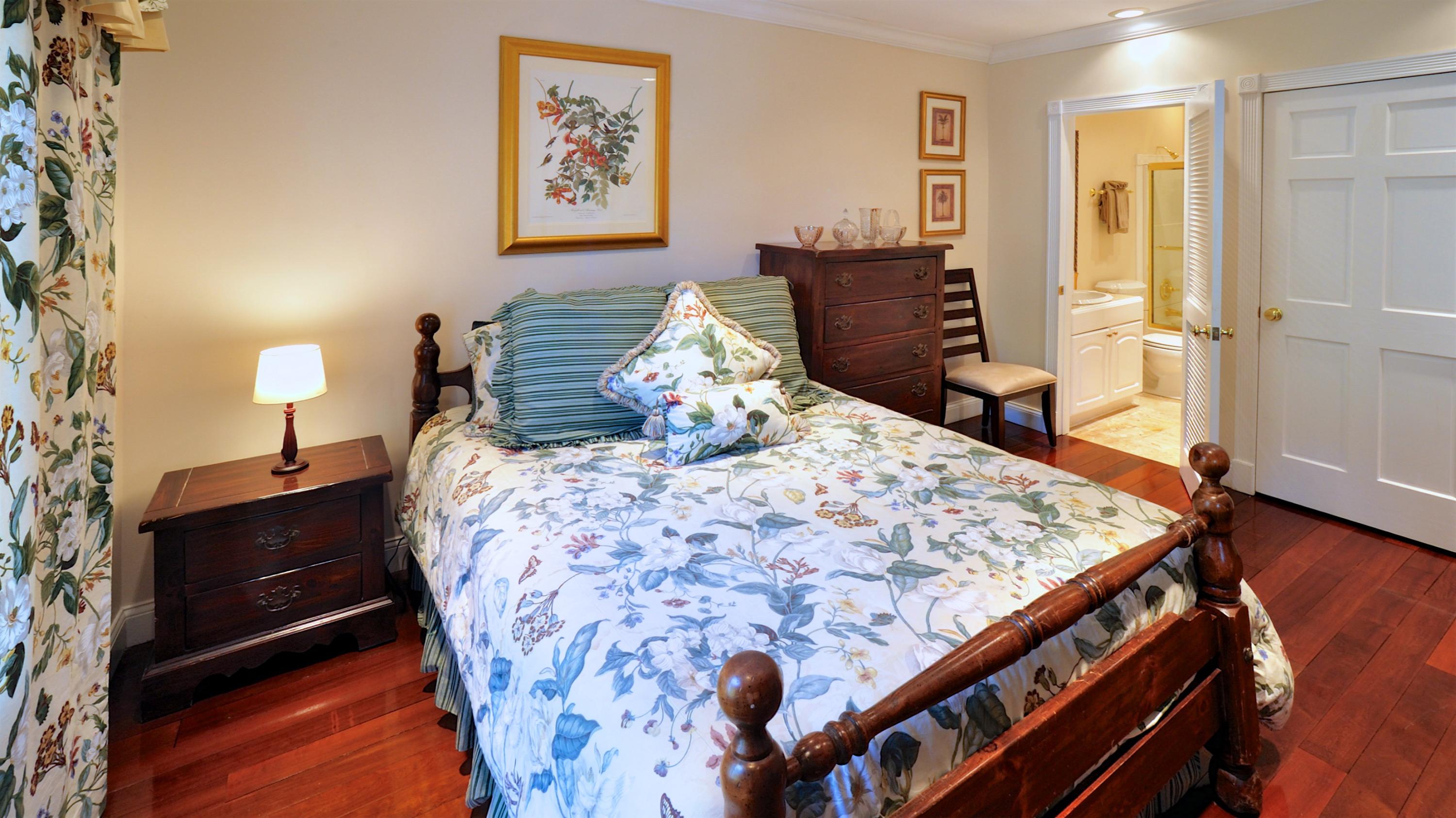 58 Front Street Key West, FL 33040 - Photo 24 of 28 a bed sitting in a bedroom next to a window with dresser