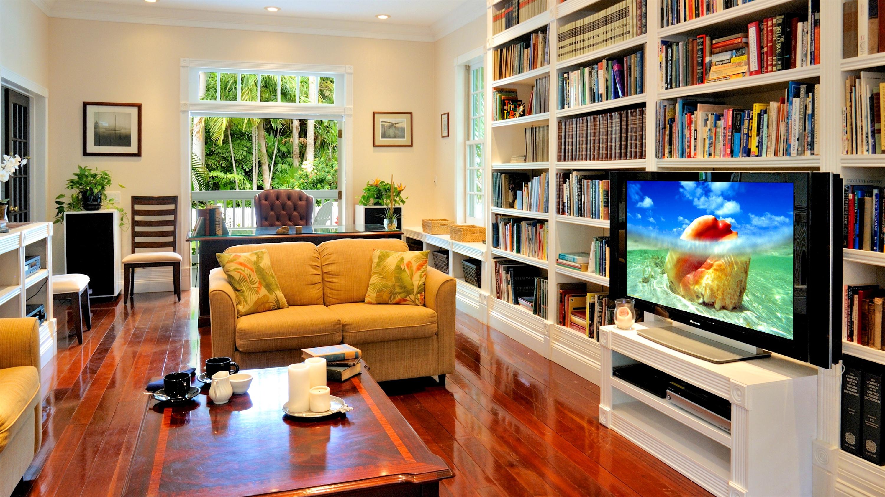 58 Front Street Key West, FL 33040 - Photo 7 of 28 a living room with furniture and a flat screen tv