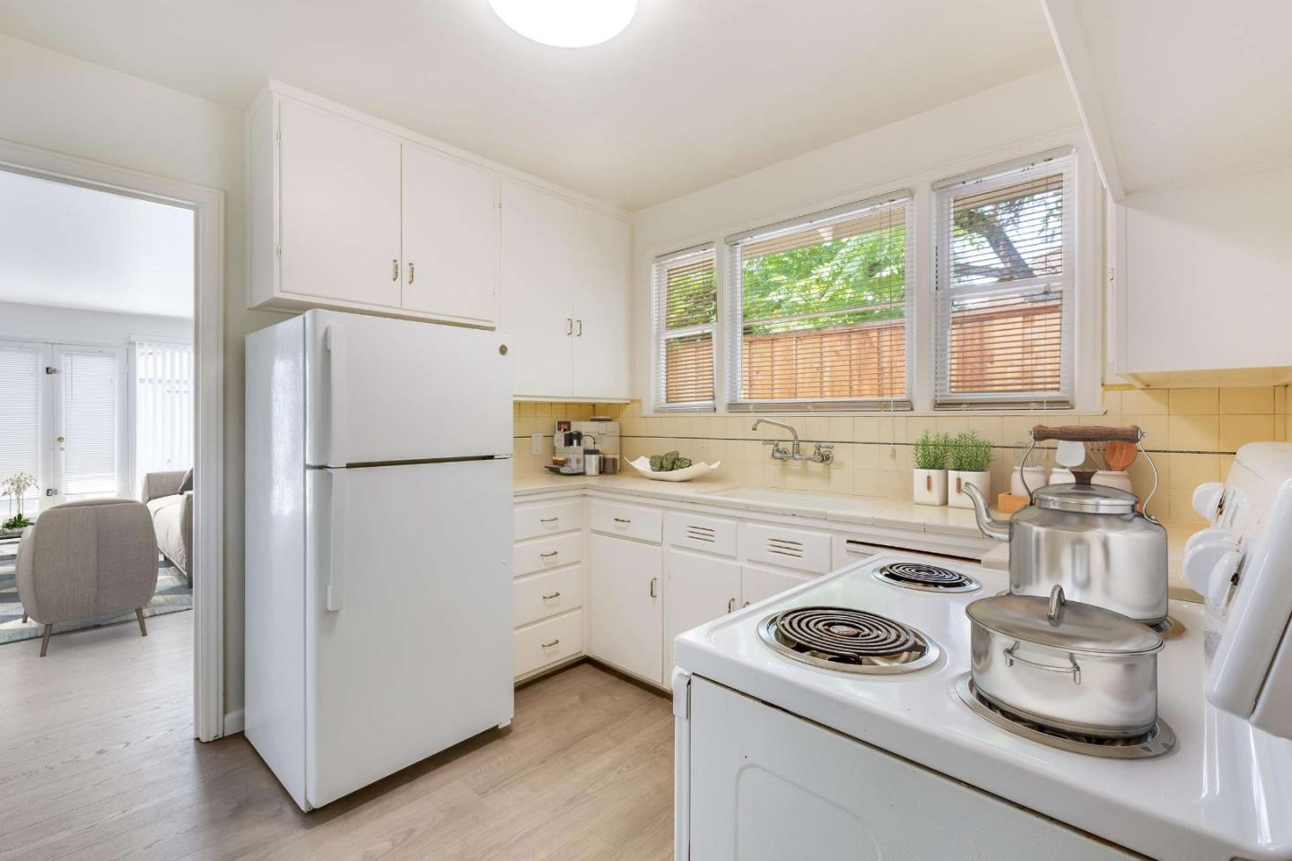 2360 Middlefield Road Palo Alto, CA 94301 - Photo 7 of 18 a kitchen with a refrigerator stove and white cabinets