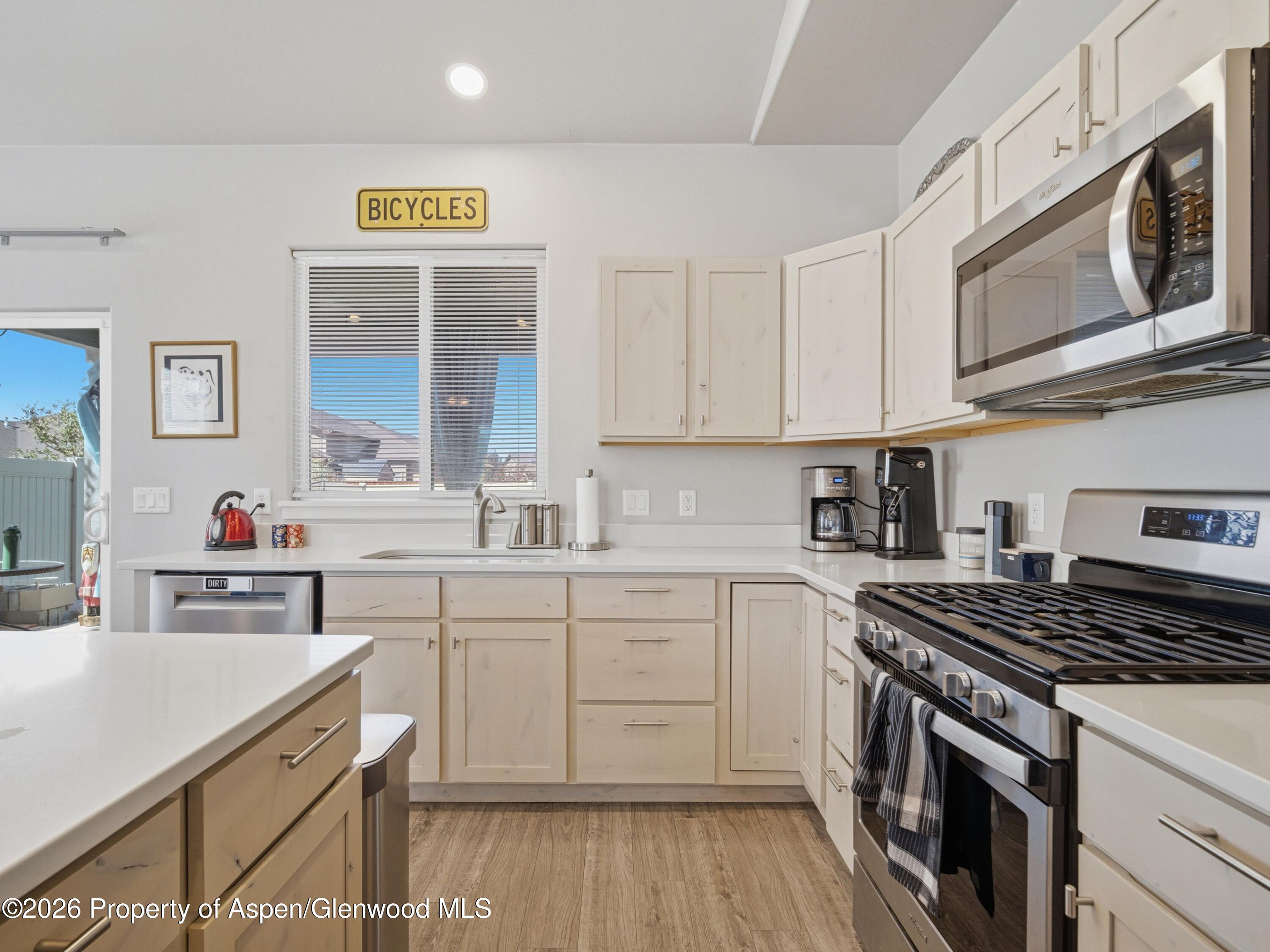 563 Red Cedar Way Grand Junction, CO 81504 - Photo 12 of 30 a kitchen with cabinets appliances a sink and a counter top space