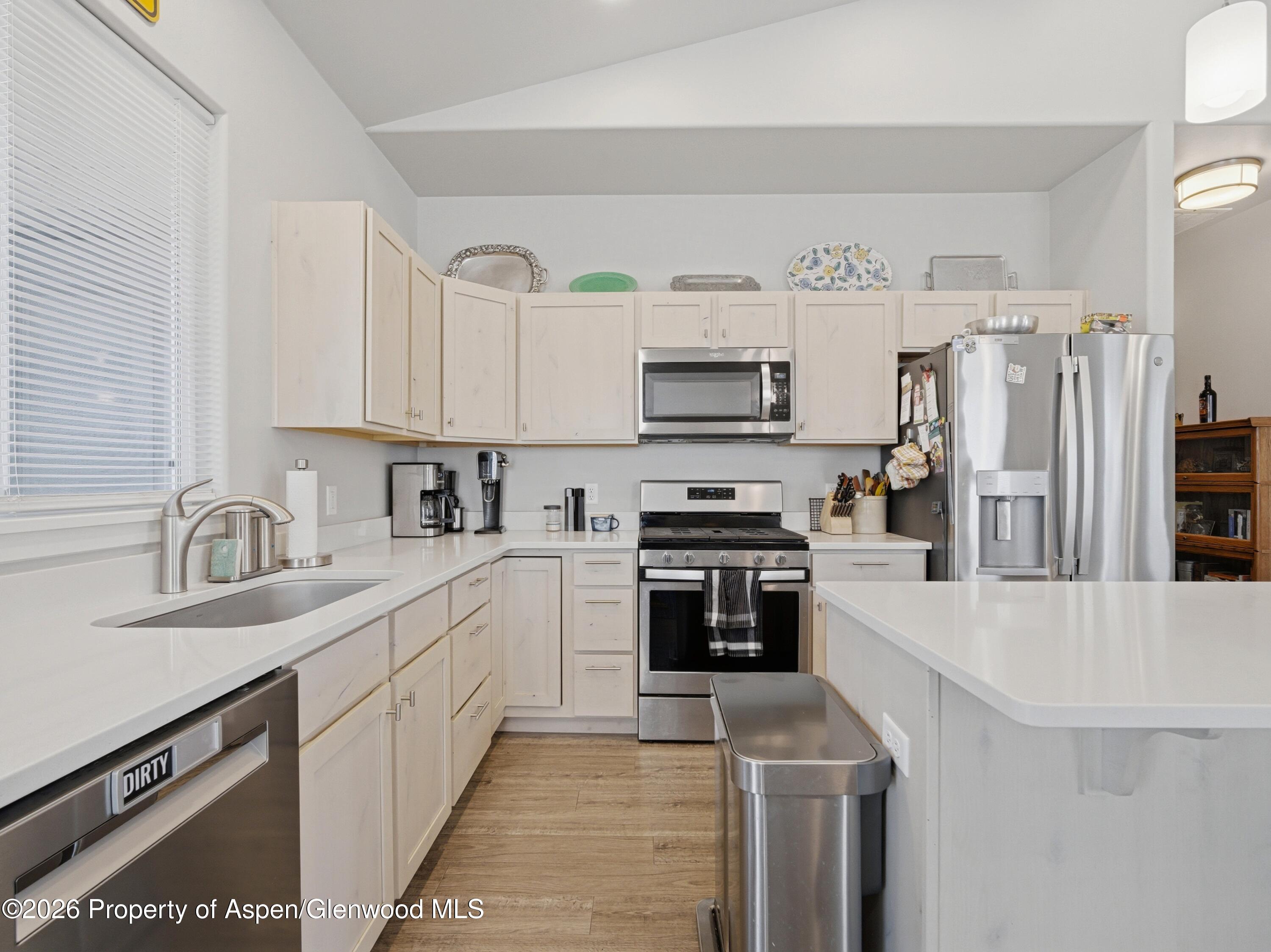 563 Red Cedar Way Grand Junction, CO 81504 - Photo 13 of 30 a kitchen with stainless steel appliances a sink cabinets and a refrigerator
