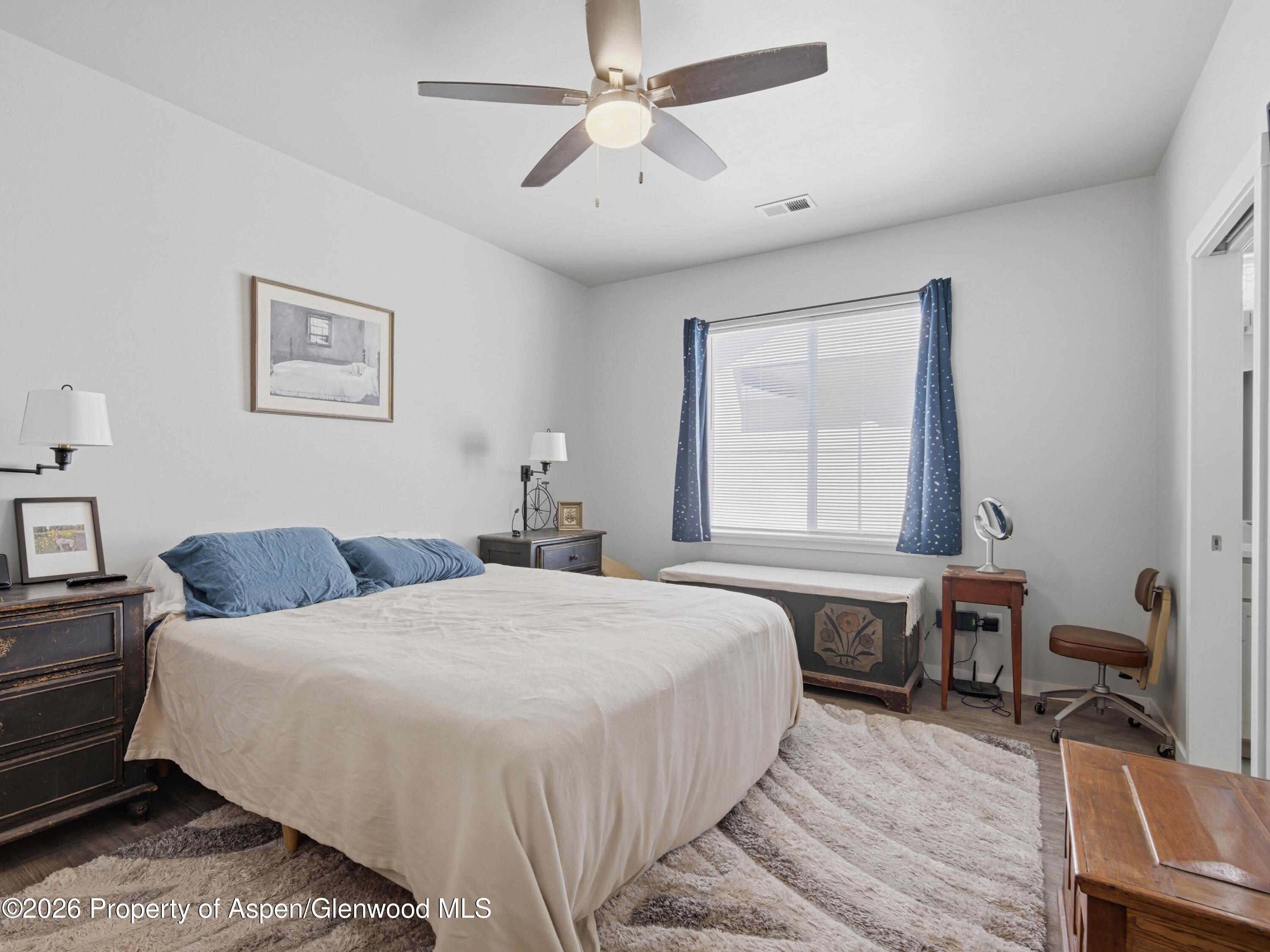 563 Red Cedar Way Grand Junction, CO 81504 - Photo 15 of 30 a bedroom with a bed dresser and a window