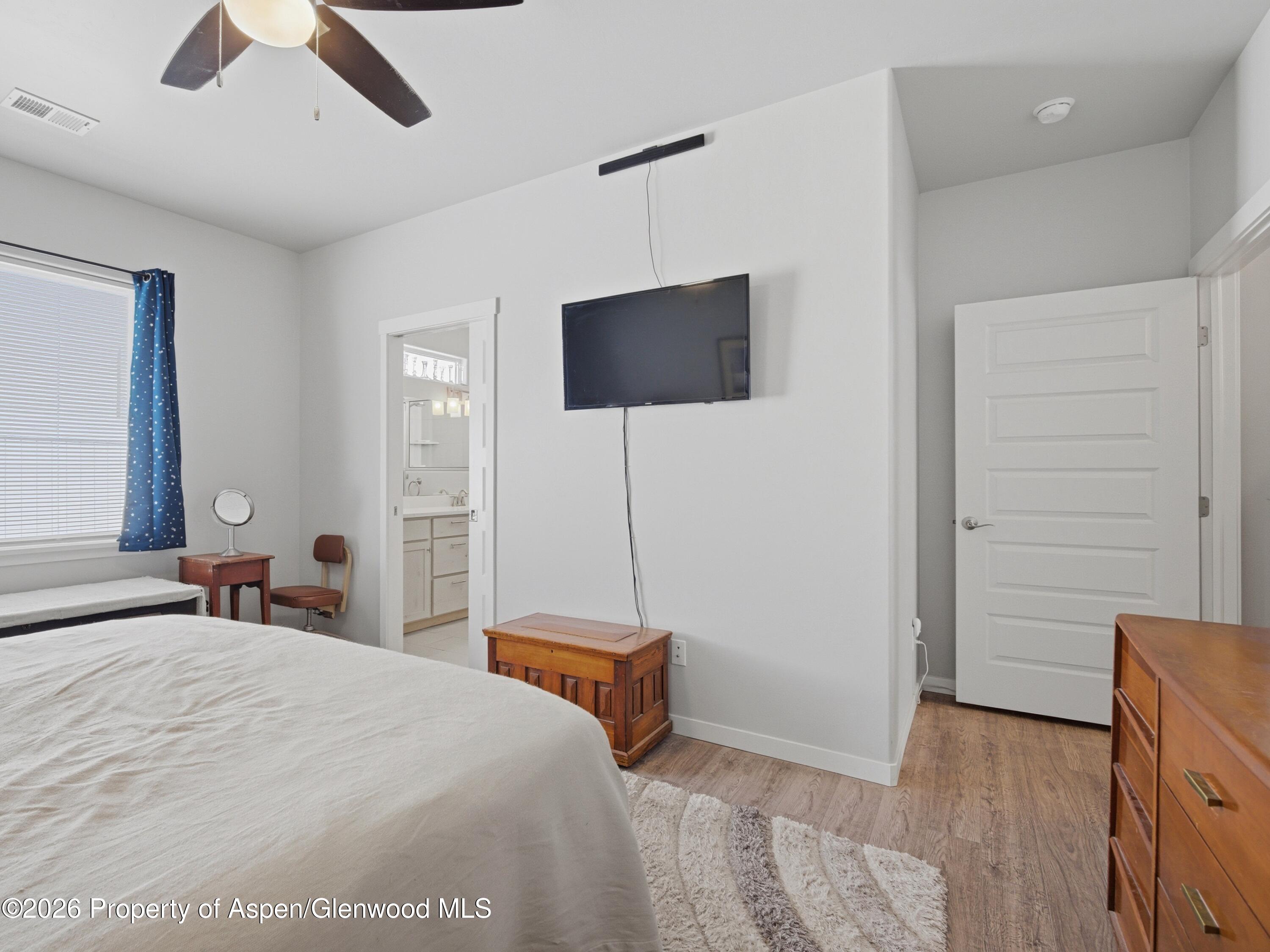 563 Red Cedar Way Grand Junction, CO 81504 - Photo 16 of 30 a bedroom with a bed and a flat screen tv