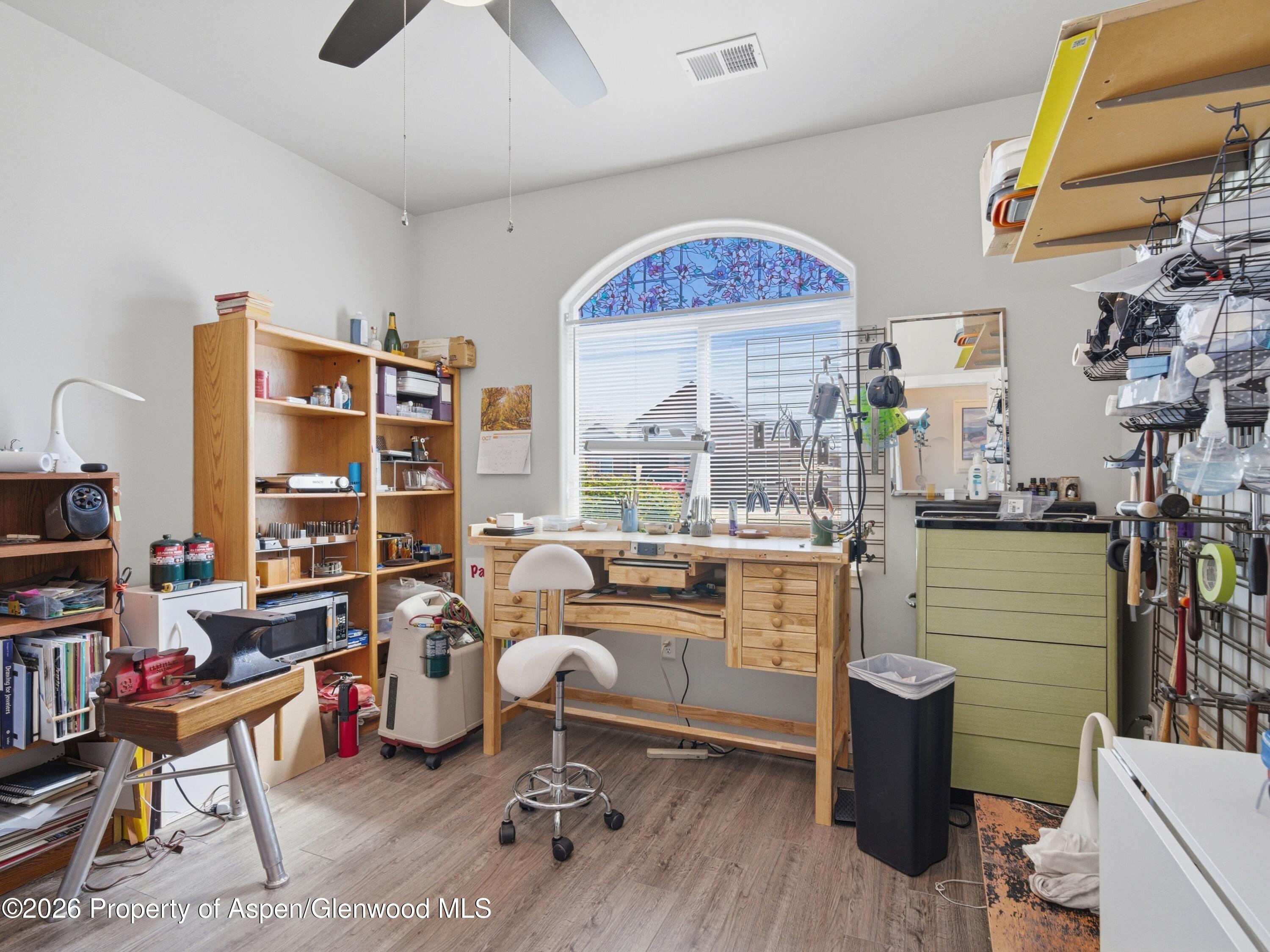 563 Red Cedar Way Grand Junction, CO 81504 - Photo 20 of 30 a living room with furniture a rug and a bookshelf