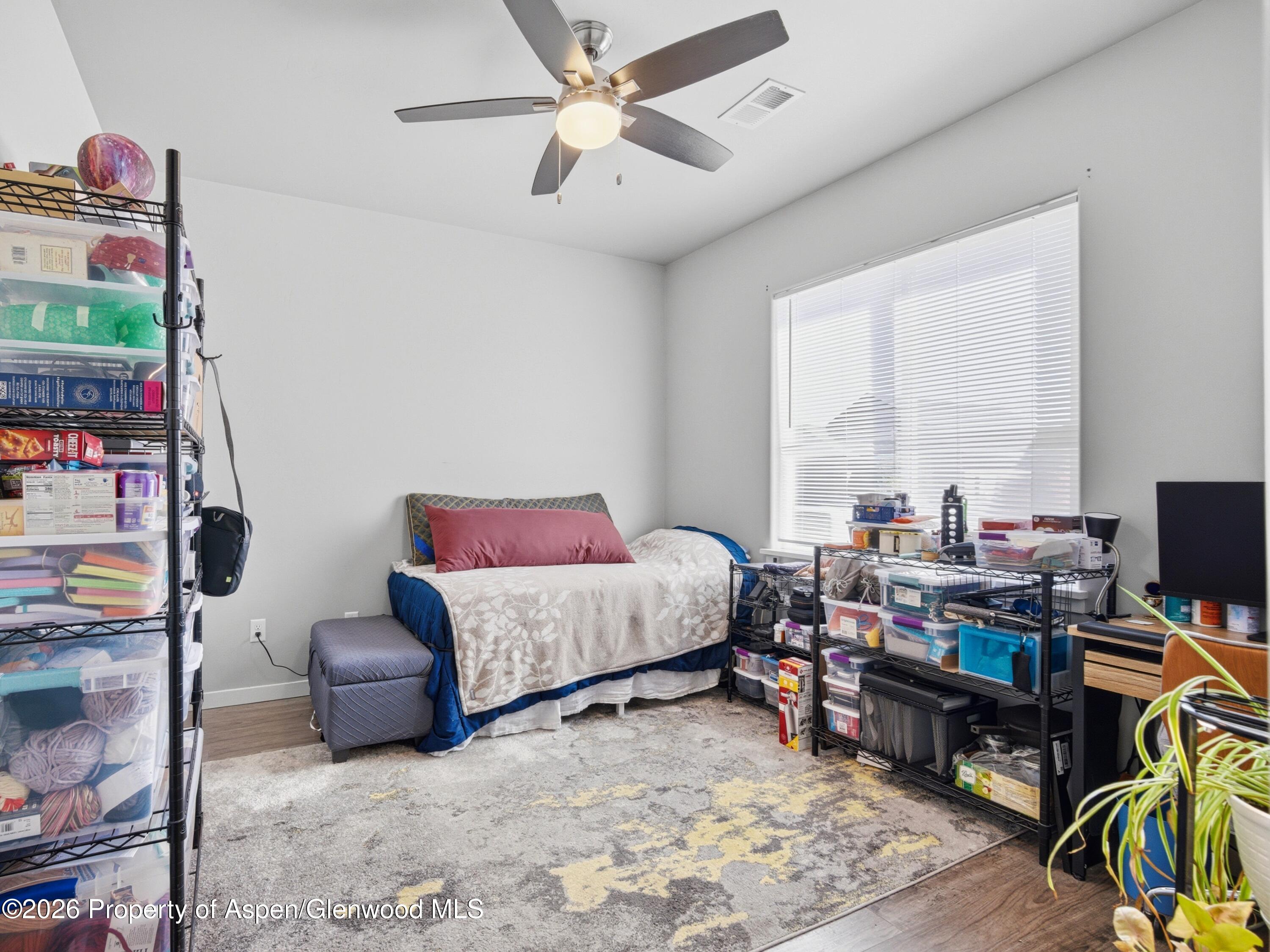 563 Red Cedar Way Grand Junction, CO 81504 - Photo 23 of 30 a bedroom with furniture and a window