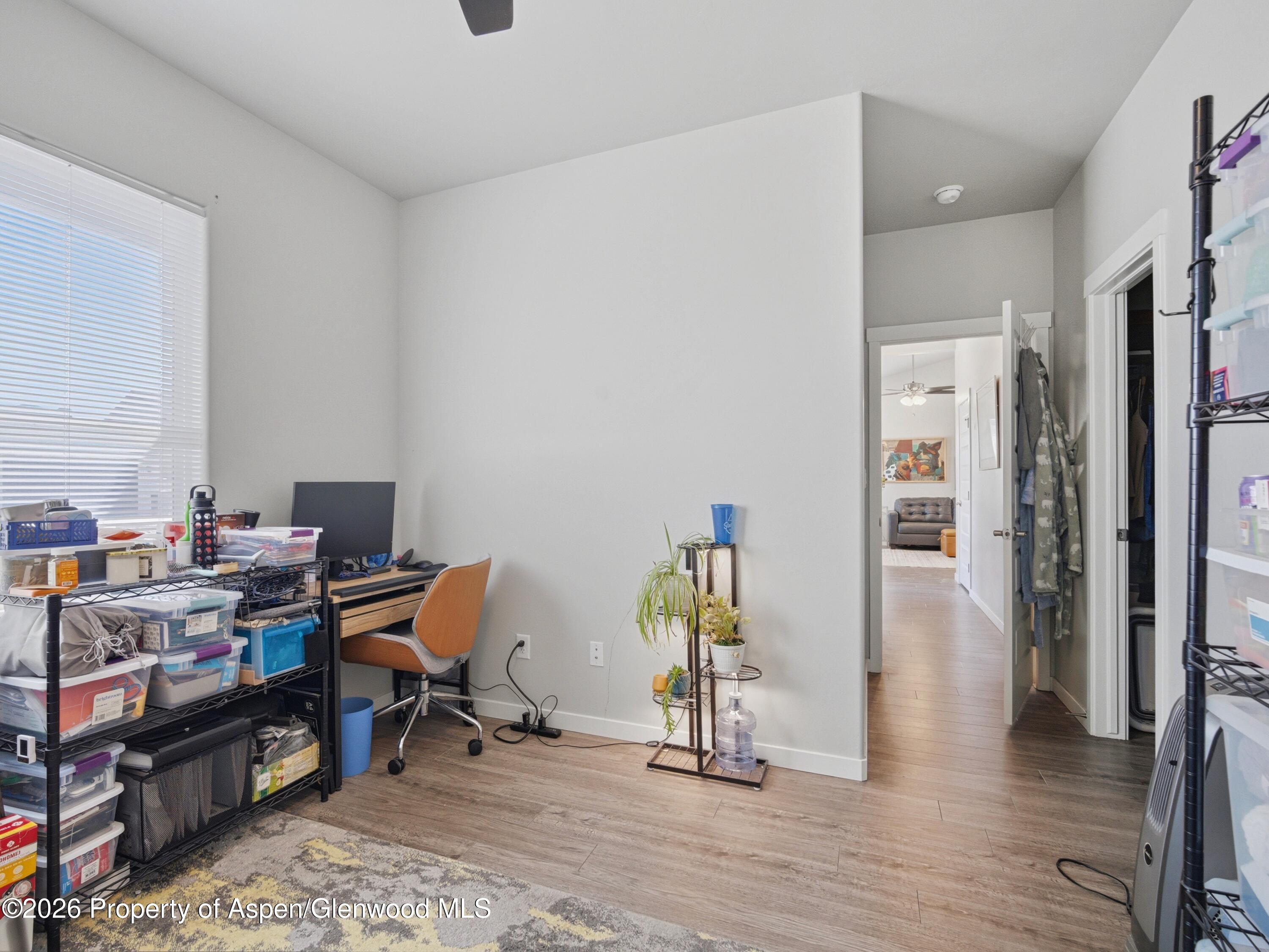 563 Red Cedar Way Grand Junction, CO 81504 - Photo 24 of 30 a view of a workspace with furniture and wooden floor