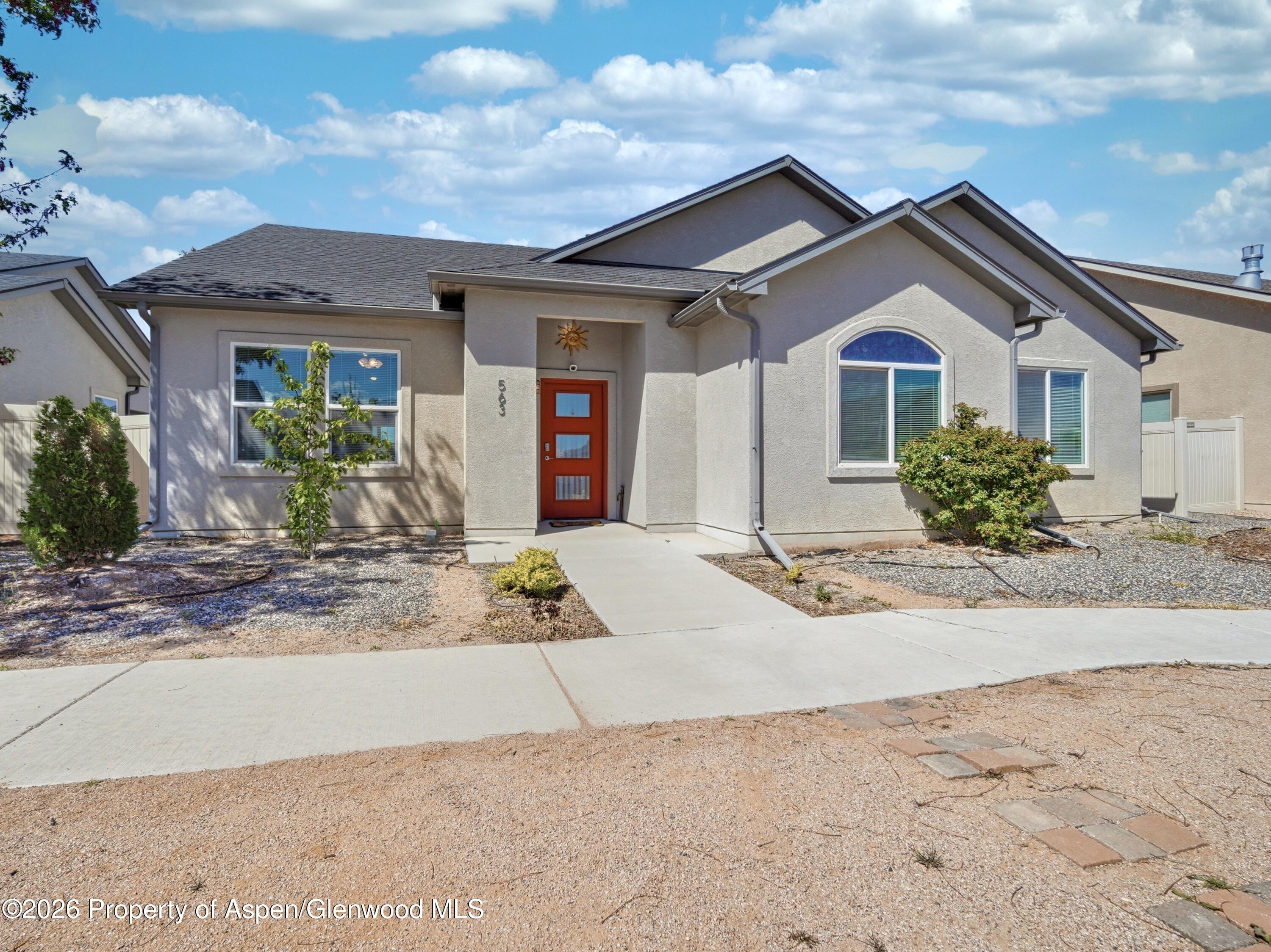 563 Red Cedar Way Grand Junction, CO 81504 - Photo 3 of 30 a front view of a house with yard