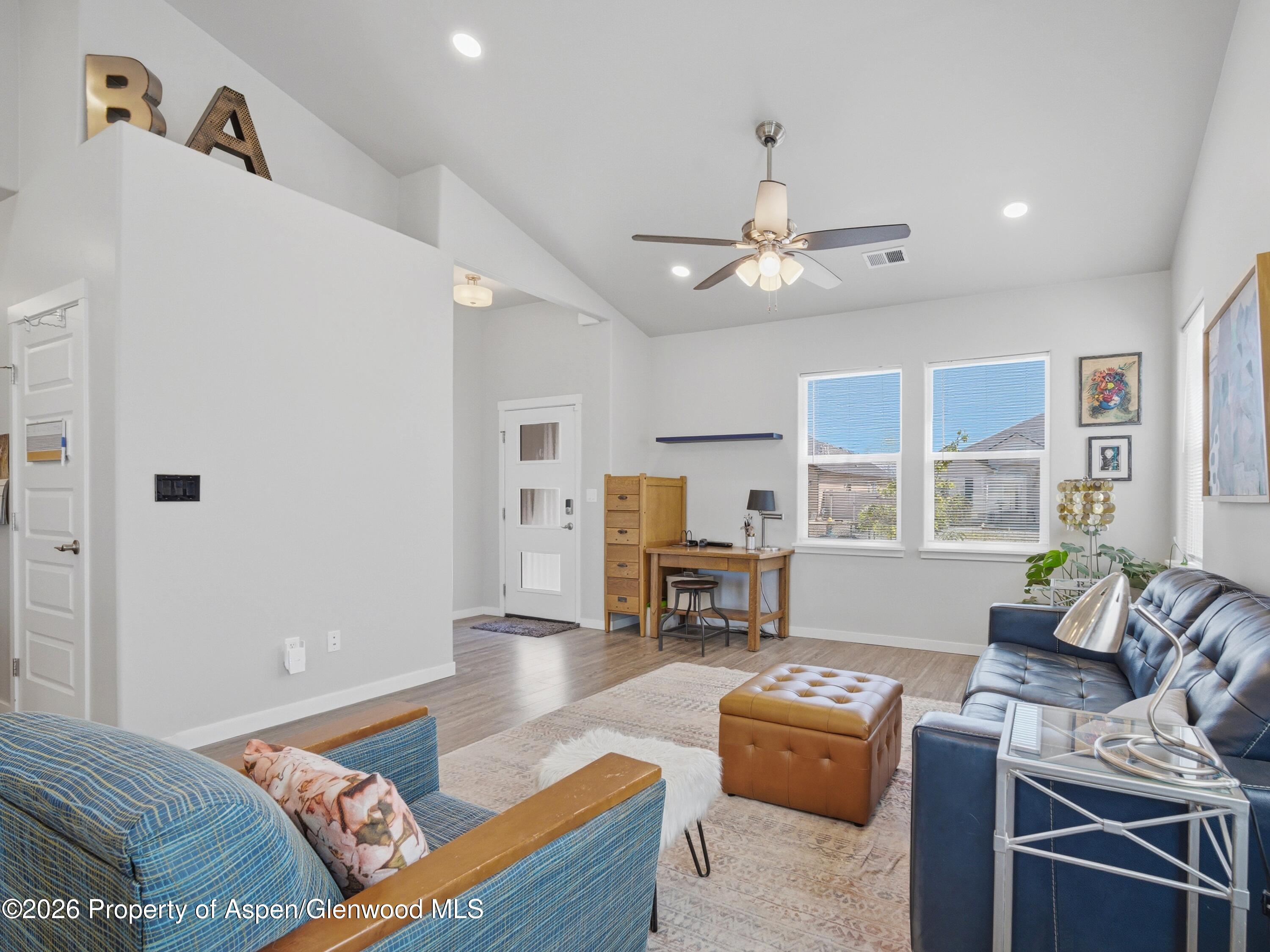 563 Red Cedar Way Grand Junction, CO 81504 - Photo 7 of 30 a living room with furniture fireplace and flat screen tv