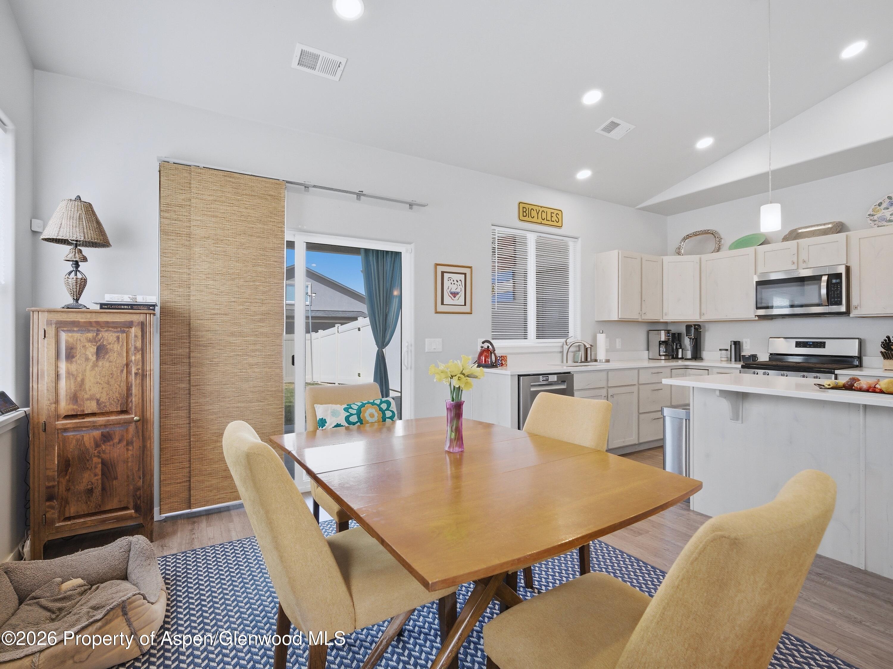 563 Red Cedar Way Grand Junction, CO 81504 - Photo 9 of 30 a view of a dining room with furniture and wooden floor