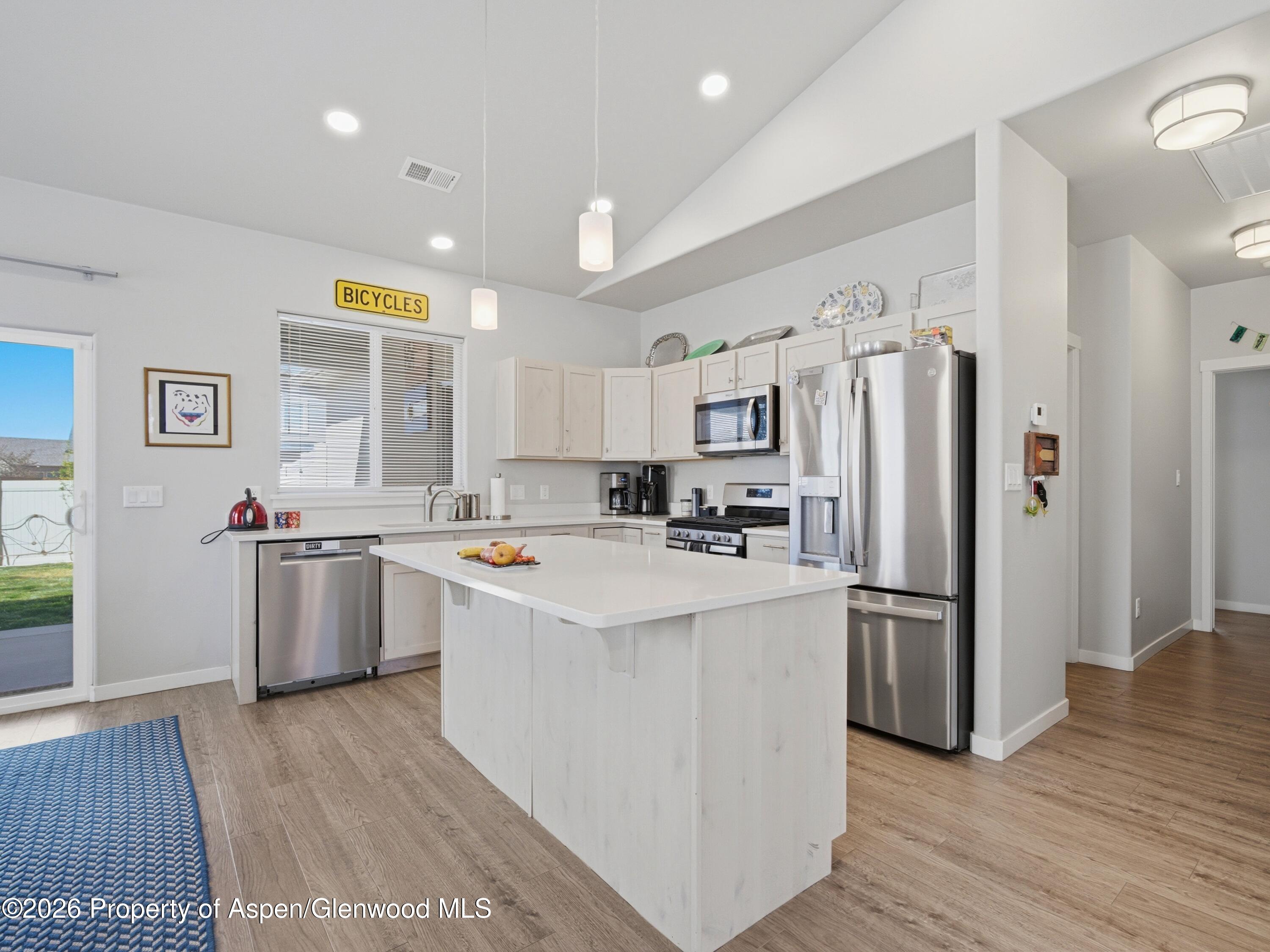 563 Red Cedar Way Grand Junction, CO 81504 - Photo 10 of 30 a kitchen with a sink a refrigerator and cabinets