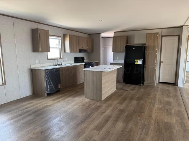 a kitchen with stainless steel appliances a refrigerator stove and sink