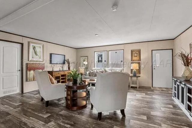 a living room with furniture a window and a flat screen tv