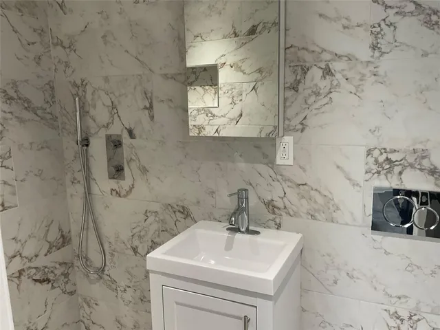 a bathroom with a sink and mirror