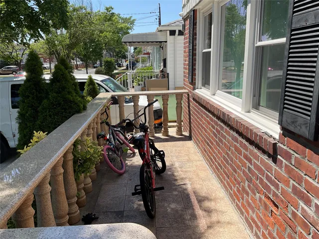 a balcony with wooden floor and outdoor seating