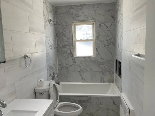 a bath room with a toilet and a bath tub