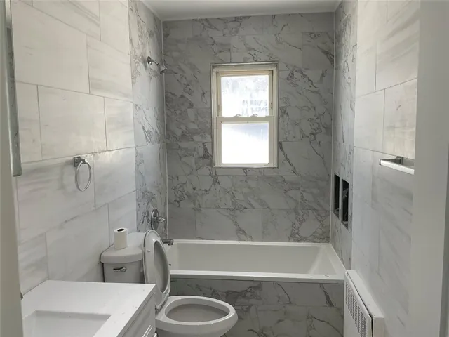 a bath room with a bath tub and a shower