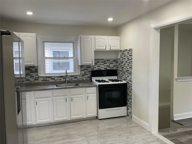 a kitchen with stainless steel appliances granite countertop a stove and a sink