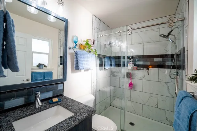 a bathroom with a sink toilet and shower