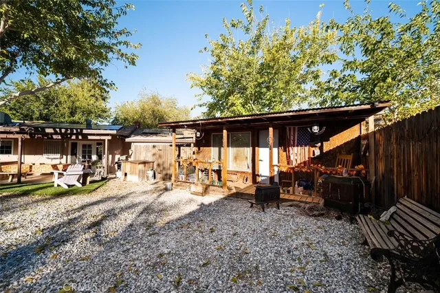 a view of a chair and tables in the back yard of the house