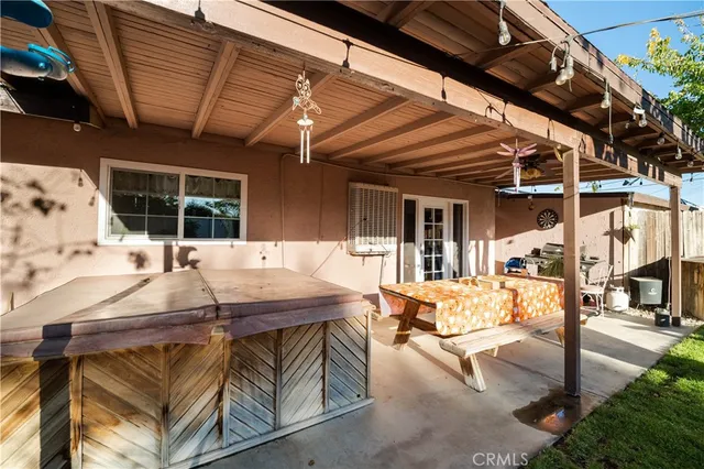 a view of a patio with table and chairs a barbeque with potted plants