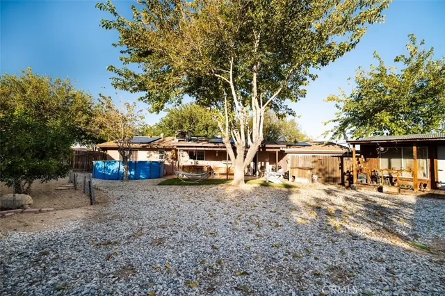 a view of a yard with car parked on the road