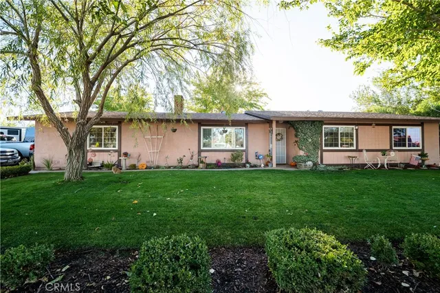 a front view of house with yard and green space
