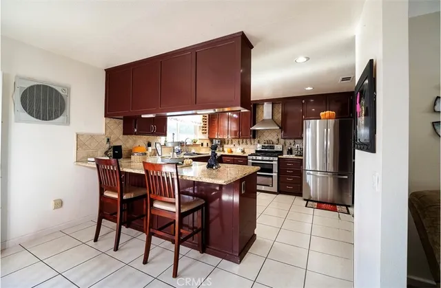 a kitchen with a sink a microwave and refrigerator