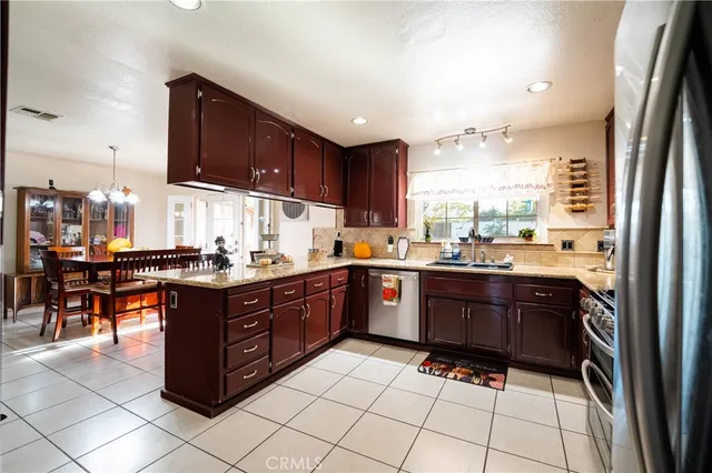 a kitchen with stainless steel appliances granite countertop a sink and cabinets