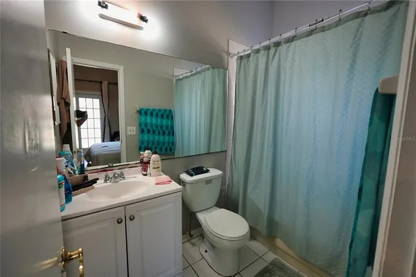 a bathroom with a toilet a sink and a mirror