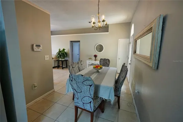 a view of a dining room with furniture and a chandelier