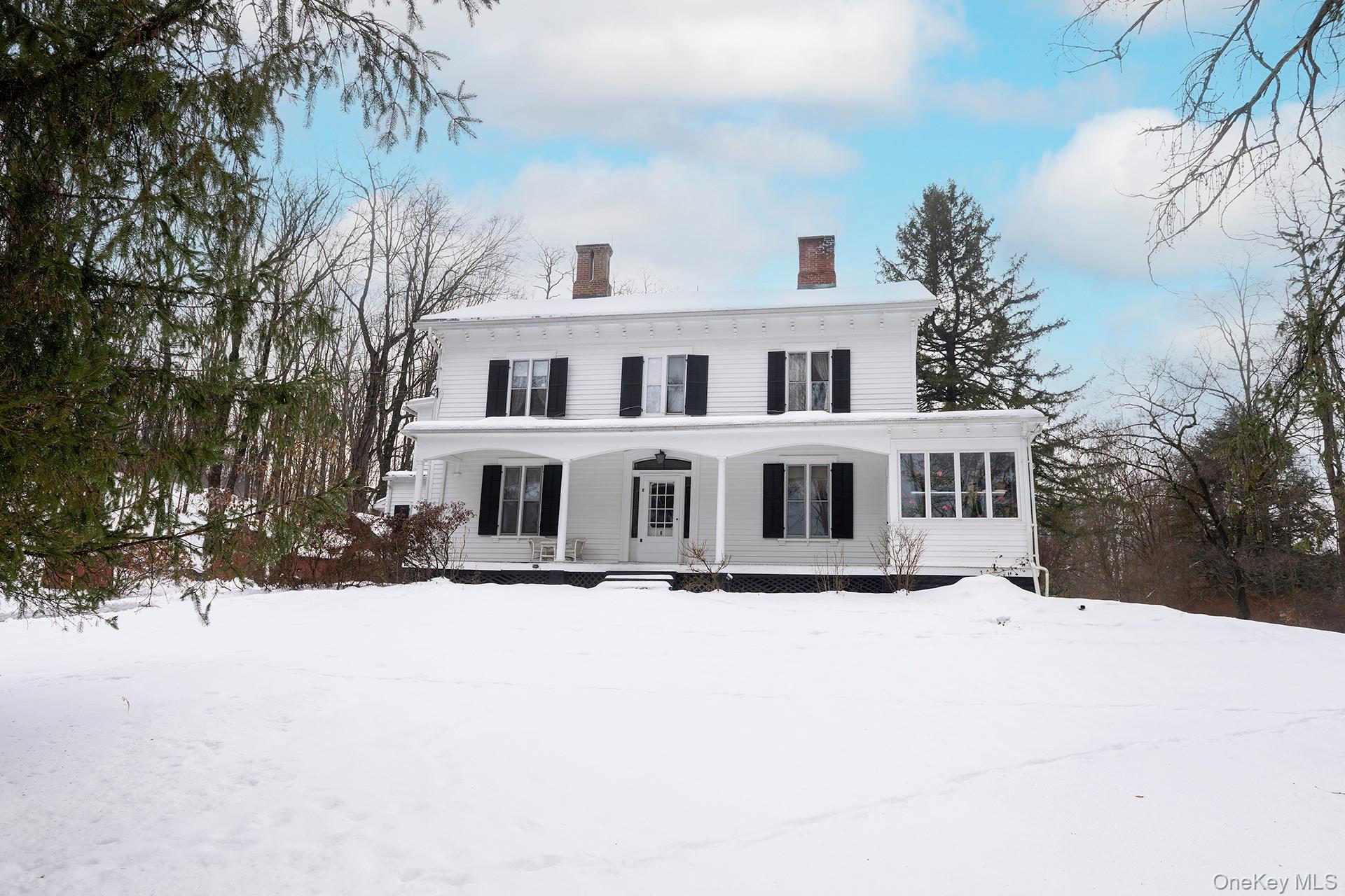 819 Van Wagner Road Poughkeepsie, NY 12601 - Photo 1 of 44 a front view of a house with a yard covered in snow