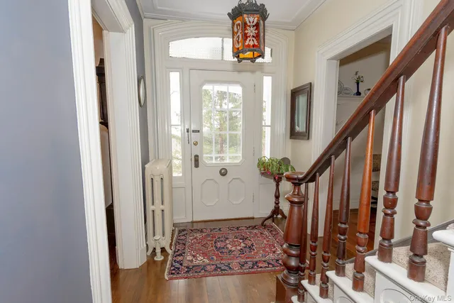 a view of an entryway with wooden floor and stairs