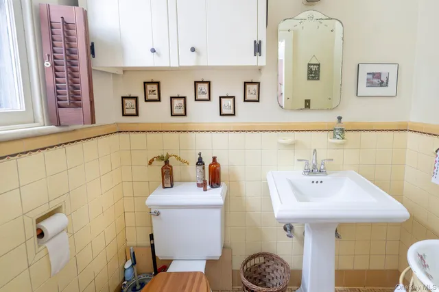 a bathroom with a sink a toilet and mirror