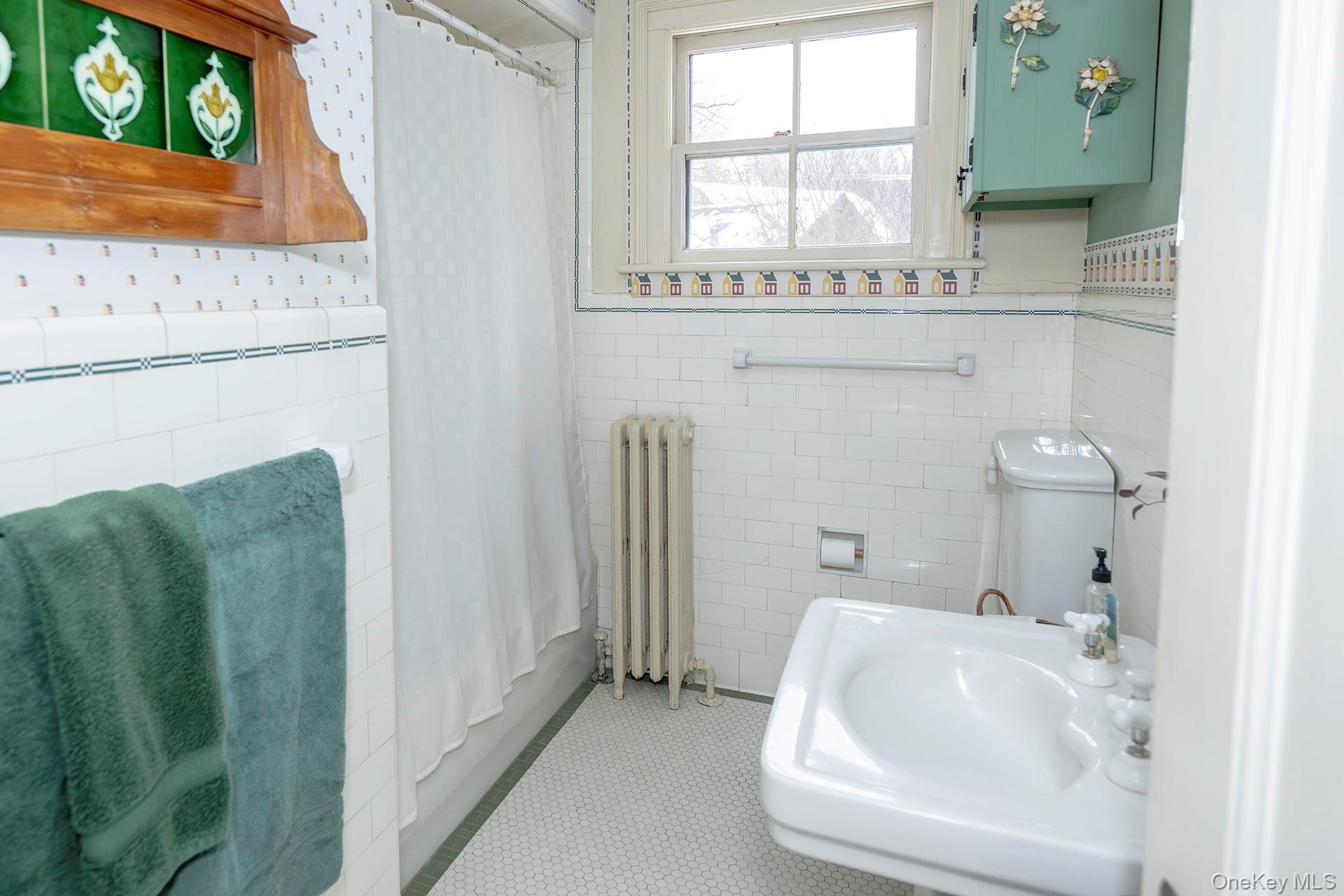 819 Van Wagner Road Poughkeepsie, NY 12601 - Photo 28 of 43 Bathroom off main hallway combination with curtain, wainscoting, wallpapered walls, and tile walls