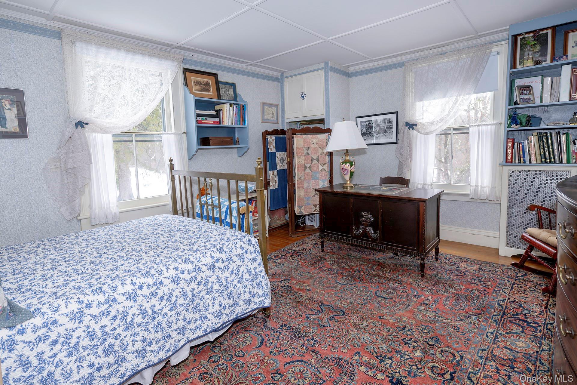 819 Van Wagner Road Poughkeepsie, NY 12601 - Photo 34 of 44 a bedroom with furniture and a book shelf