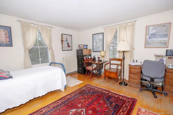 a bed room with a bed and a chair