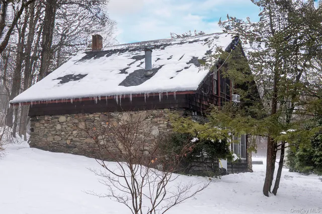 a view of a house with a snow in the yard