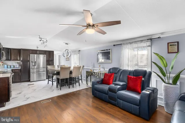 a living room with furniture kitchen view and a dining table