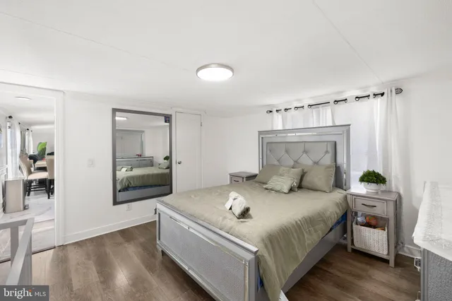 a bedroom with a bed and a mirror