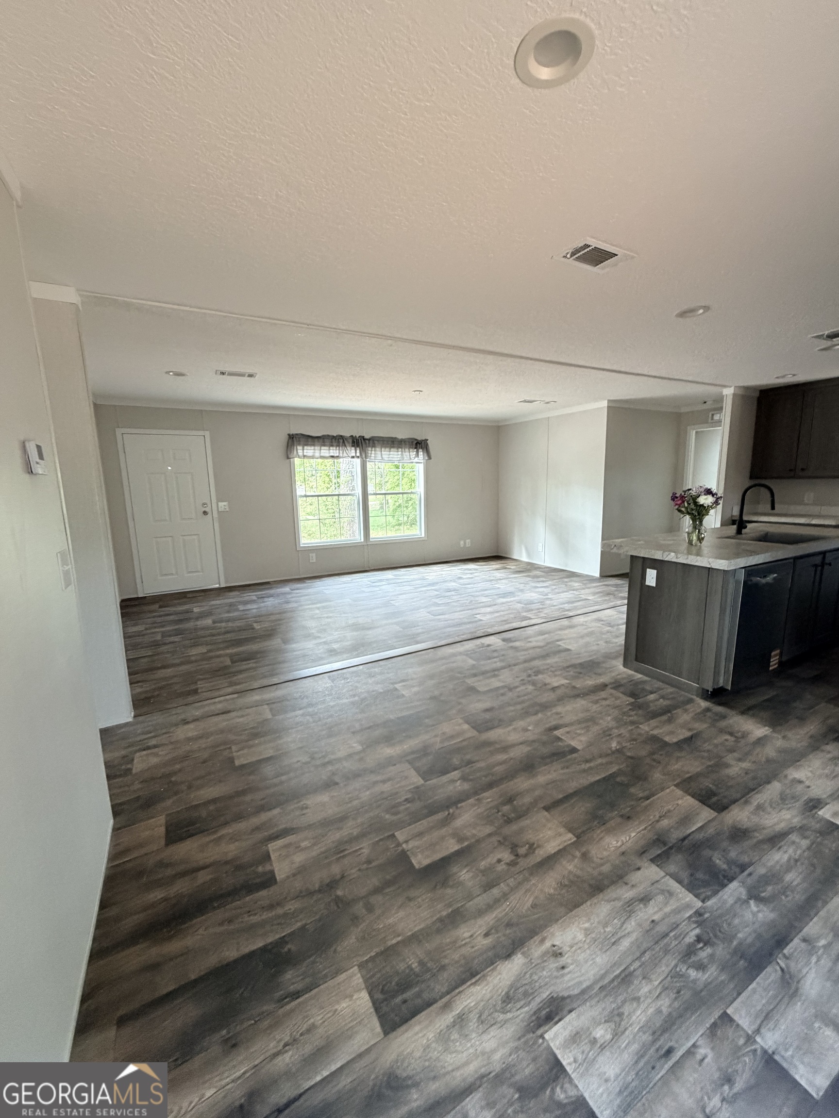 225 Rehoboth Road Bowman, GA 30624 - Photo 12 of 18 a view of empty room with wooden floor and fan
