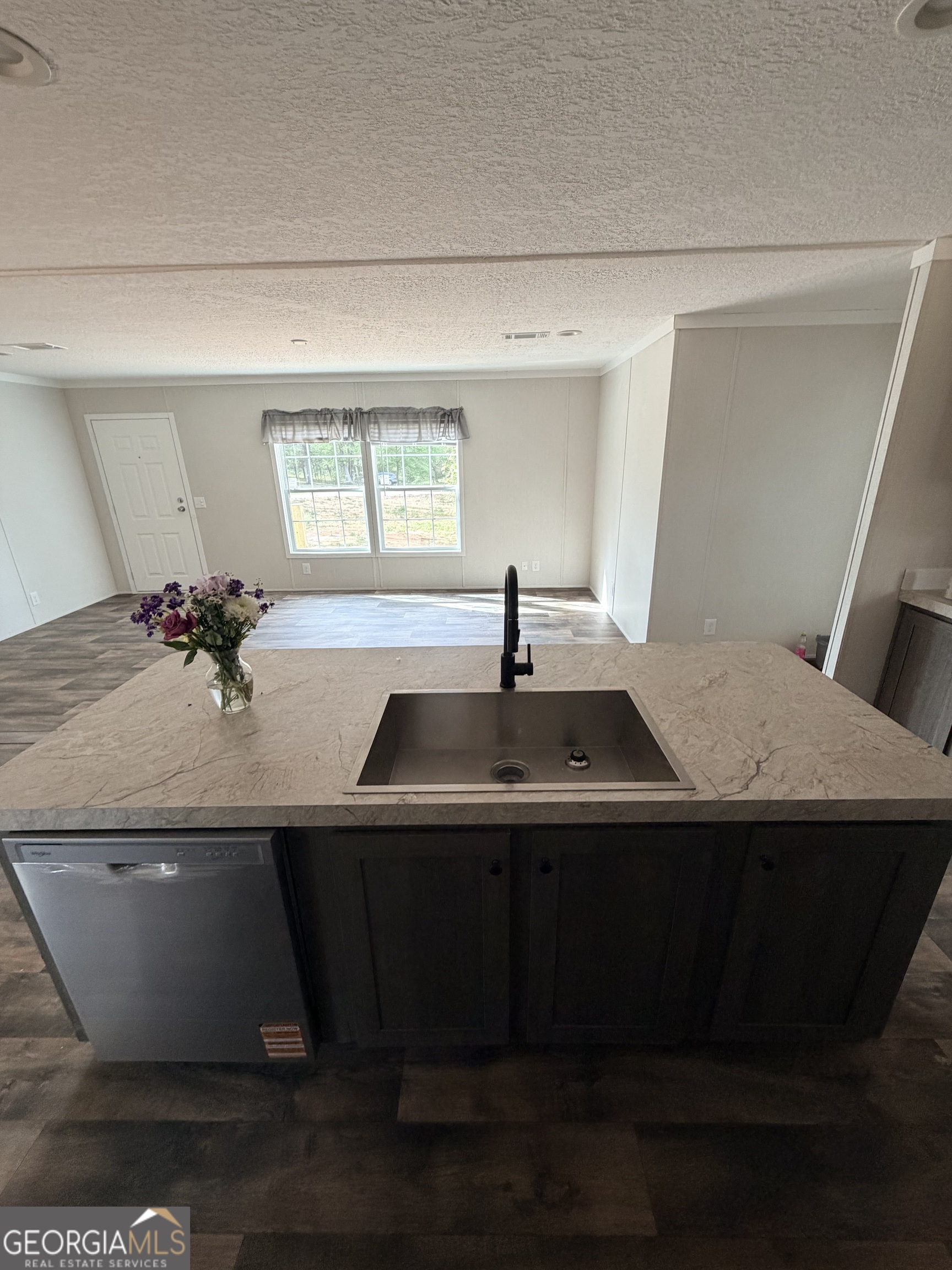 225 Rehoboth Road Bowman, GA 30624 - Photo 13 of 18 a kitchen with a sink and cabinets