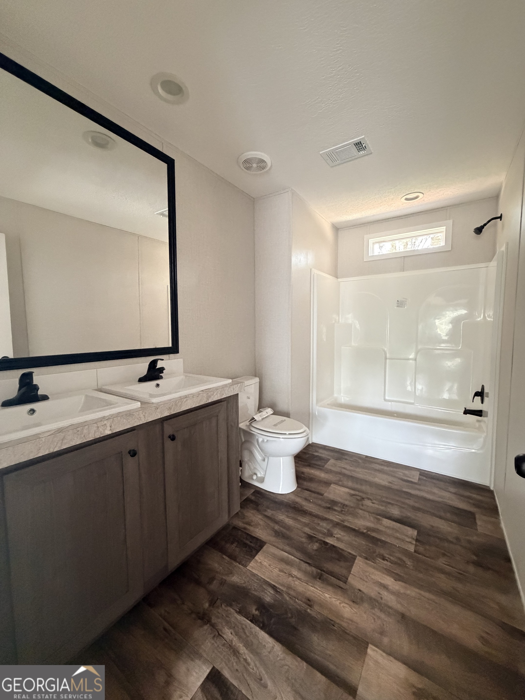 225 Rehoboth Road Bowman, GA 30624 - Photo 15 of 18 a bathroom with a double vanity sink and mirror with bathtub