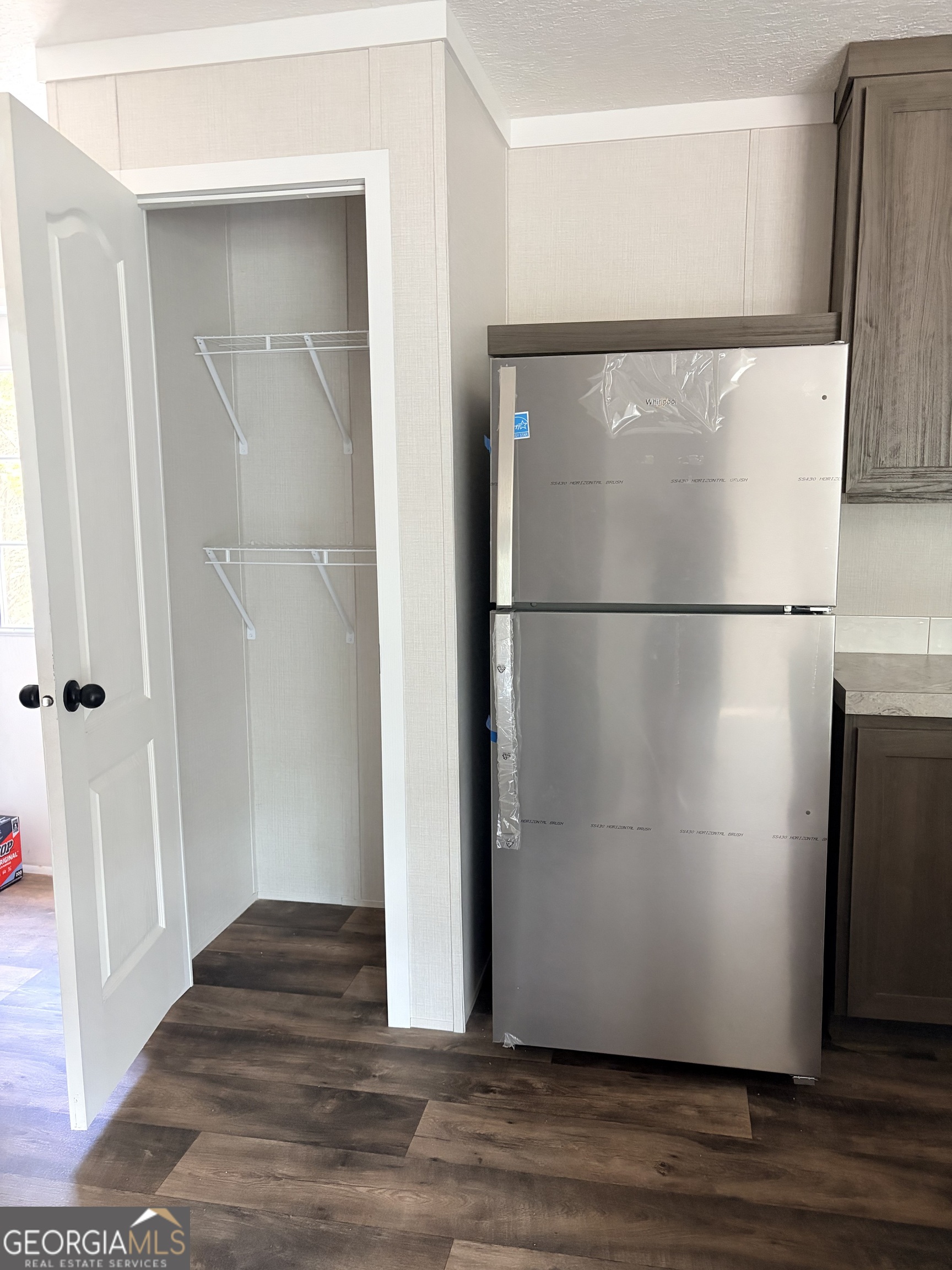 225 Rehoboth Road Bowman, GA 30624 - Photo 16 of 18 a view of a refrigerator in kitchen and wooden floor