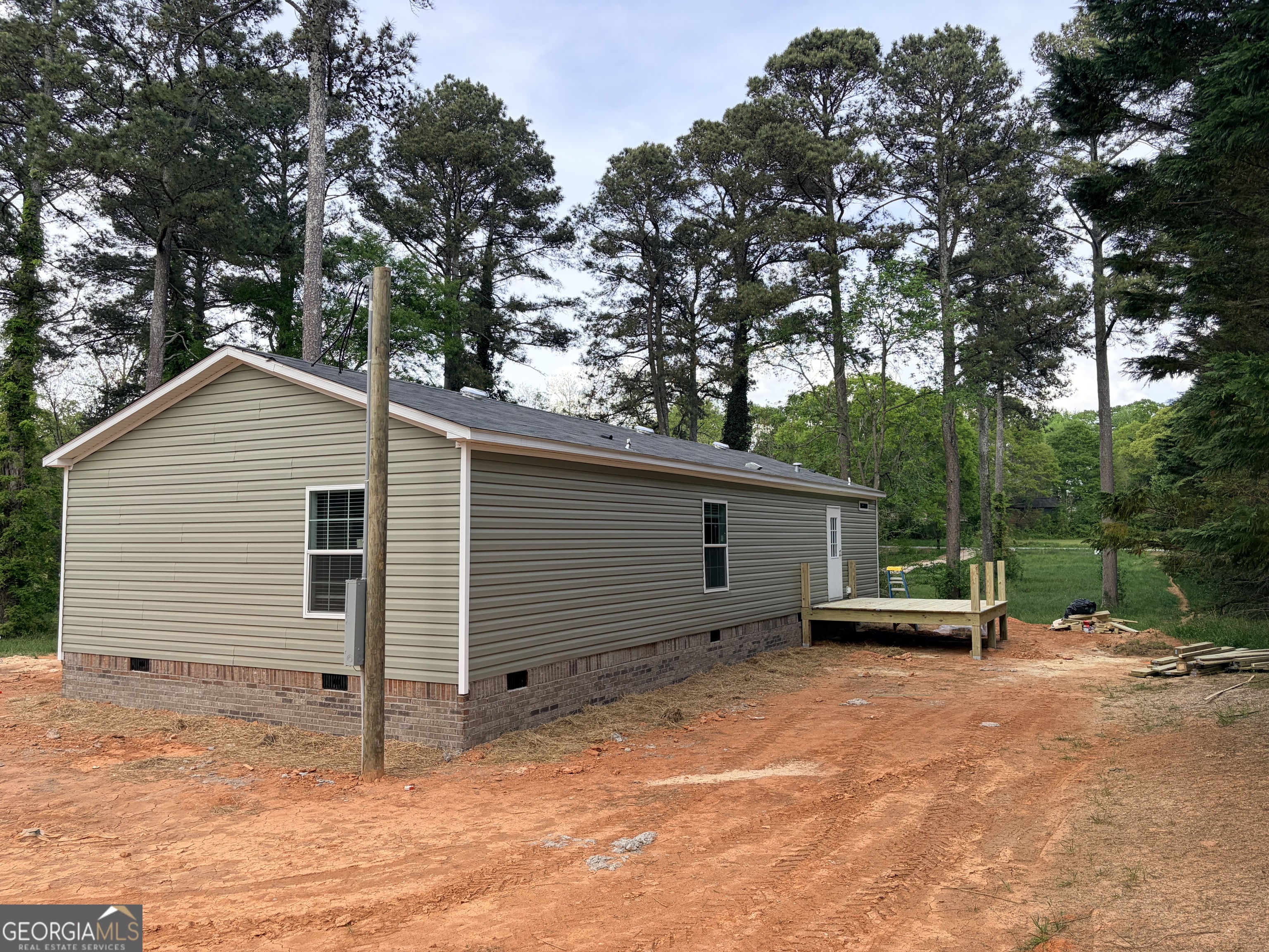 225 Rehoboth Road Bowman, GA 30624 - Photo 4 of 18 a backyard of a house with barbeque oven and trees