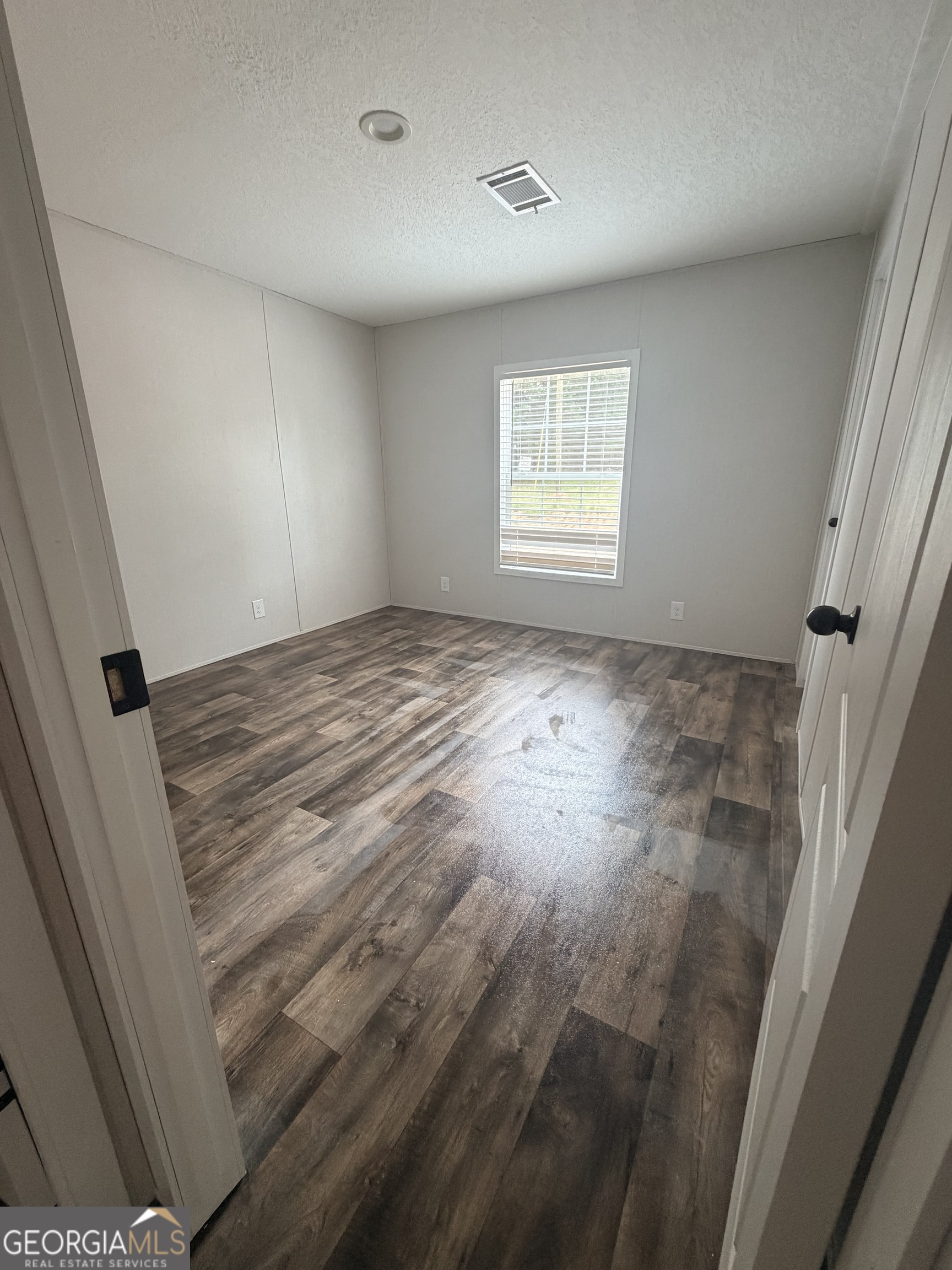 225 Rehoboth Road Bowman, GA 30624 - Photo 5 of 18 an empty room with windows