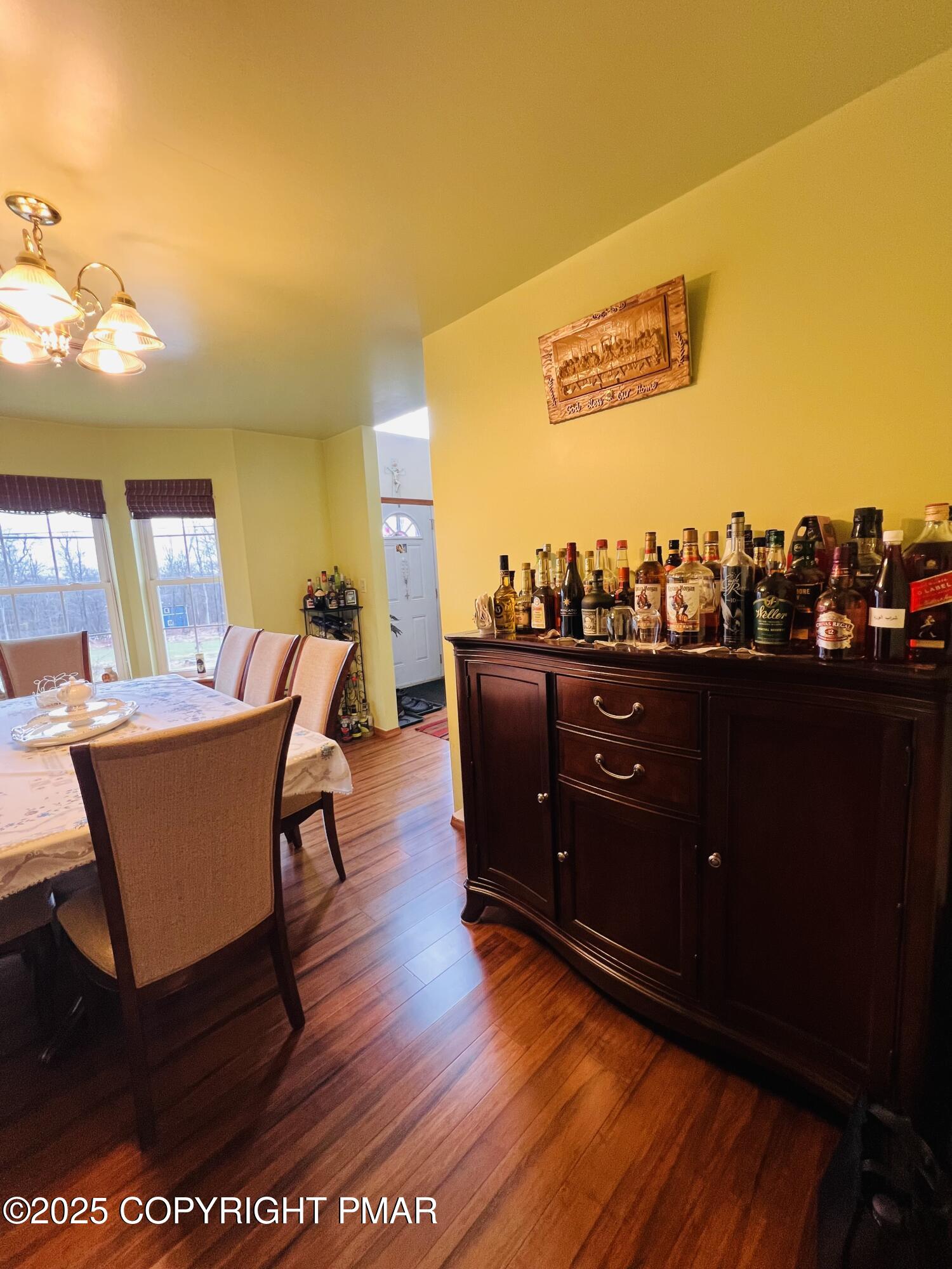 4373 Pine Ridge Drive East Bushkill, PA 18324 - Photo 13 of 39 a living room with couches chairs and a large mirror with wooden floor