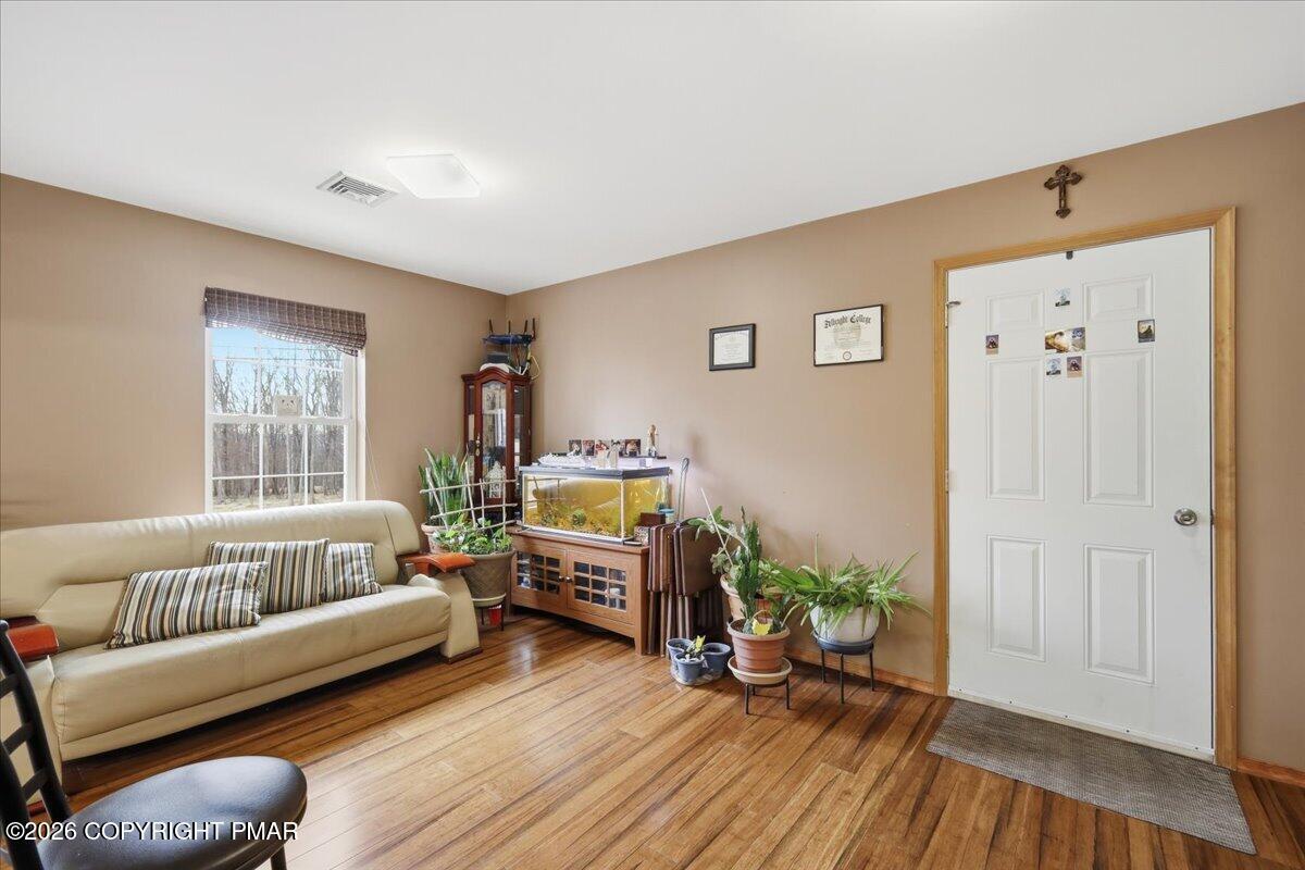 4373 Pine Ridge Drive East Bushkill, PA 18324 - Photo 16 of 33 a living room with furniture and a wooden floor