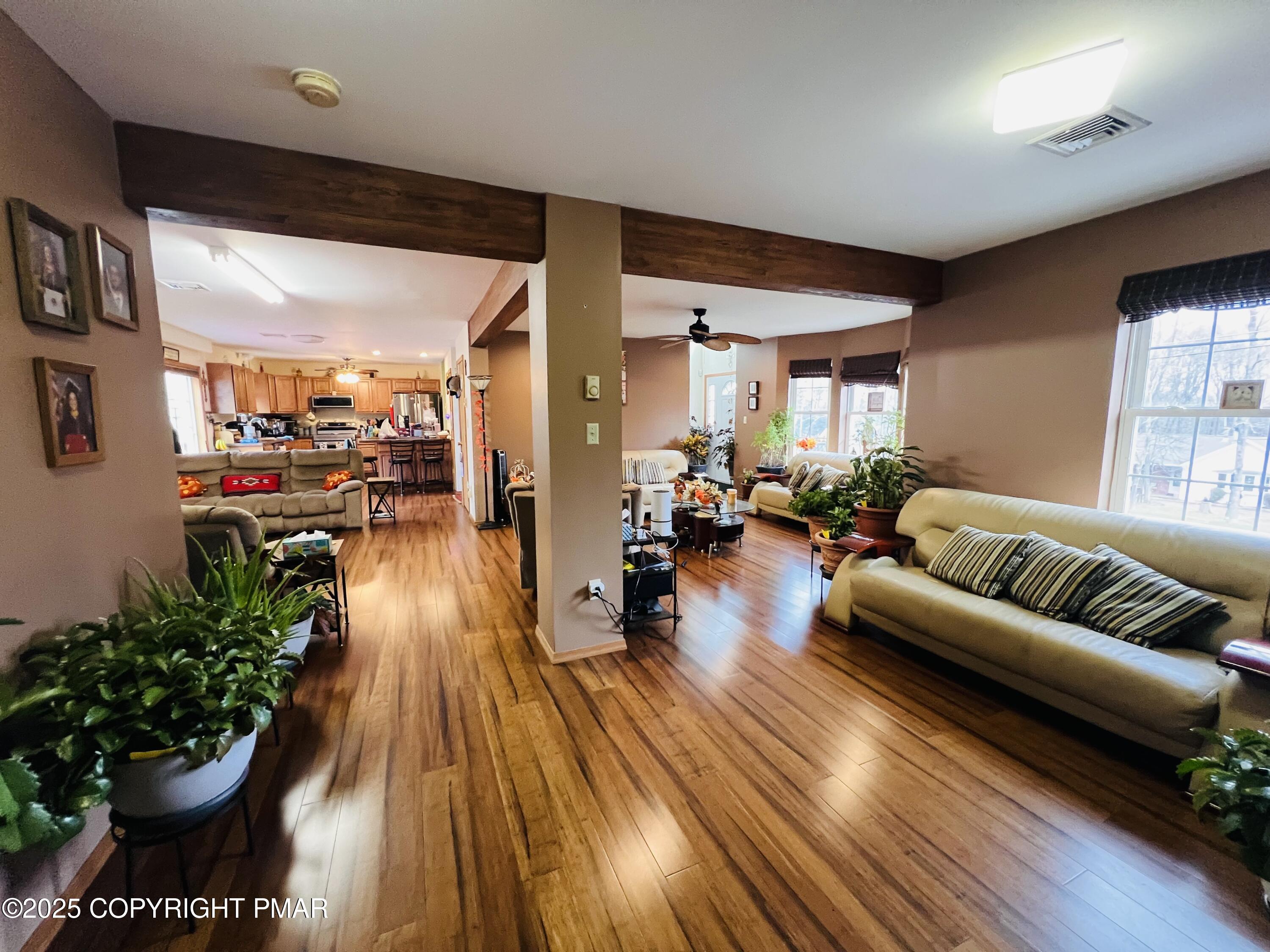 4373 Pine Ridge Drive East Bushkill, PA 18324 - Photo 16 of 39 a living room with furniture and a chandelier