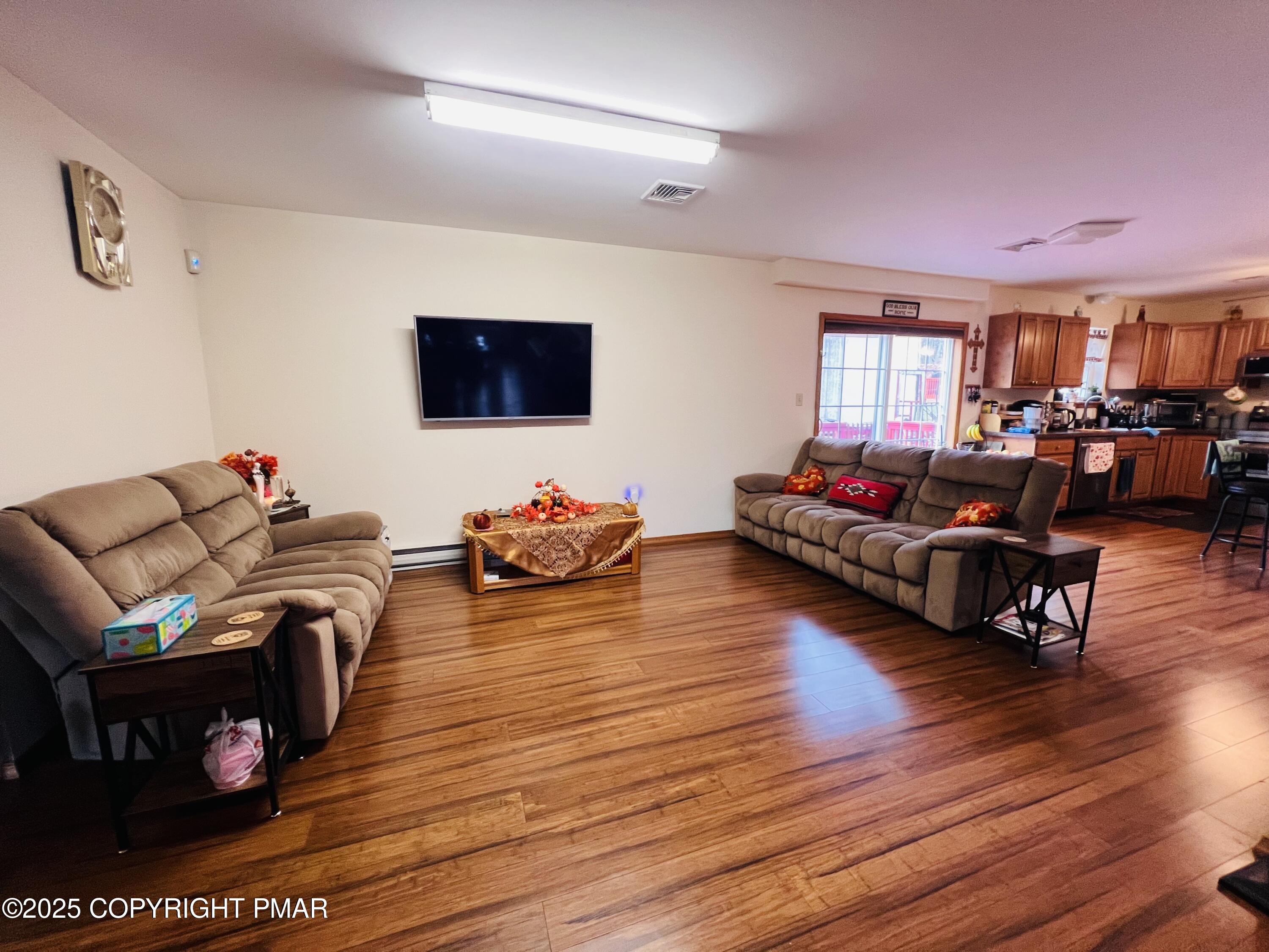4373 Pine Ridge Drive East Bushkill, PA 18324 - Photo 18 of 39 a living room with furniture and a flat screen tv
