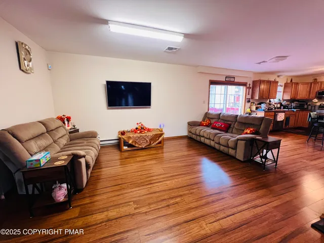a living room with furniture and a flat screen tv